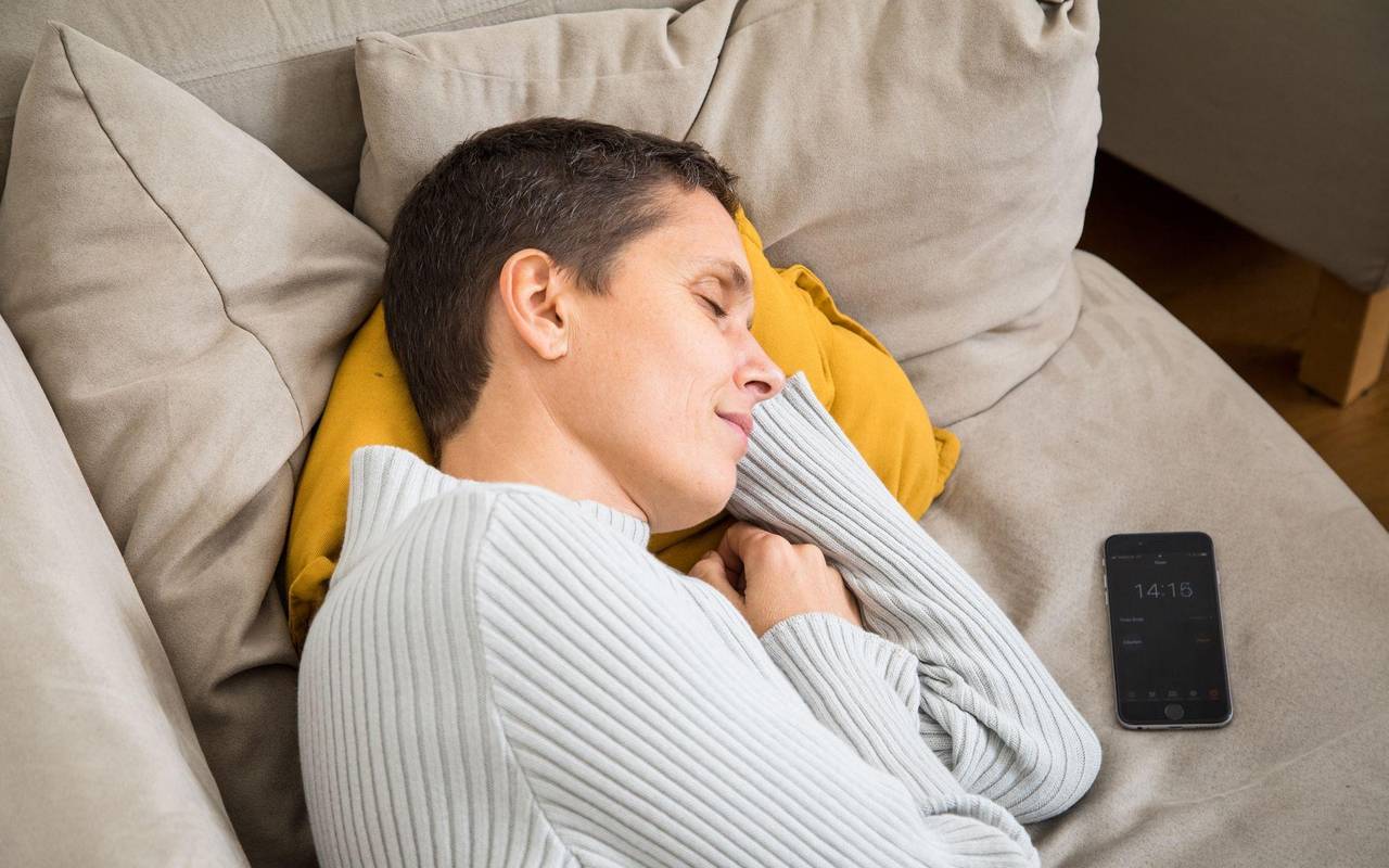 Eine Frau schläft auf einem Sofa