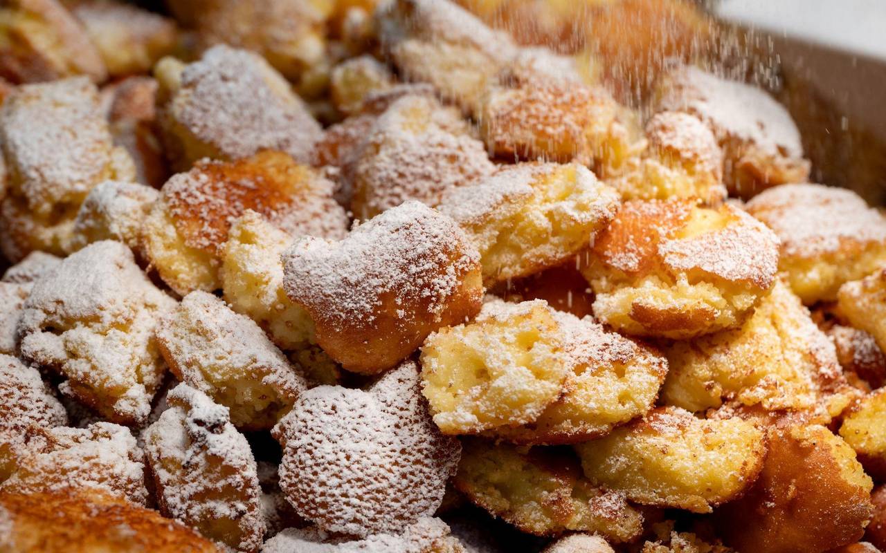 Kaiserschmarrn, der mit Puderzucker bestäubt wird